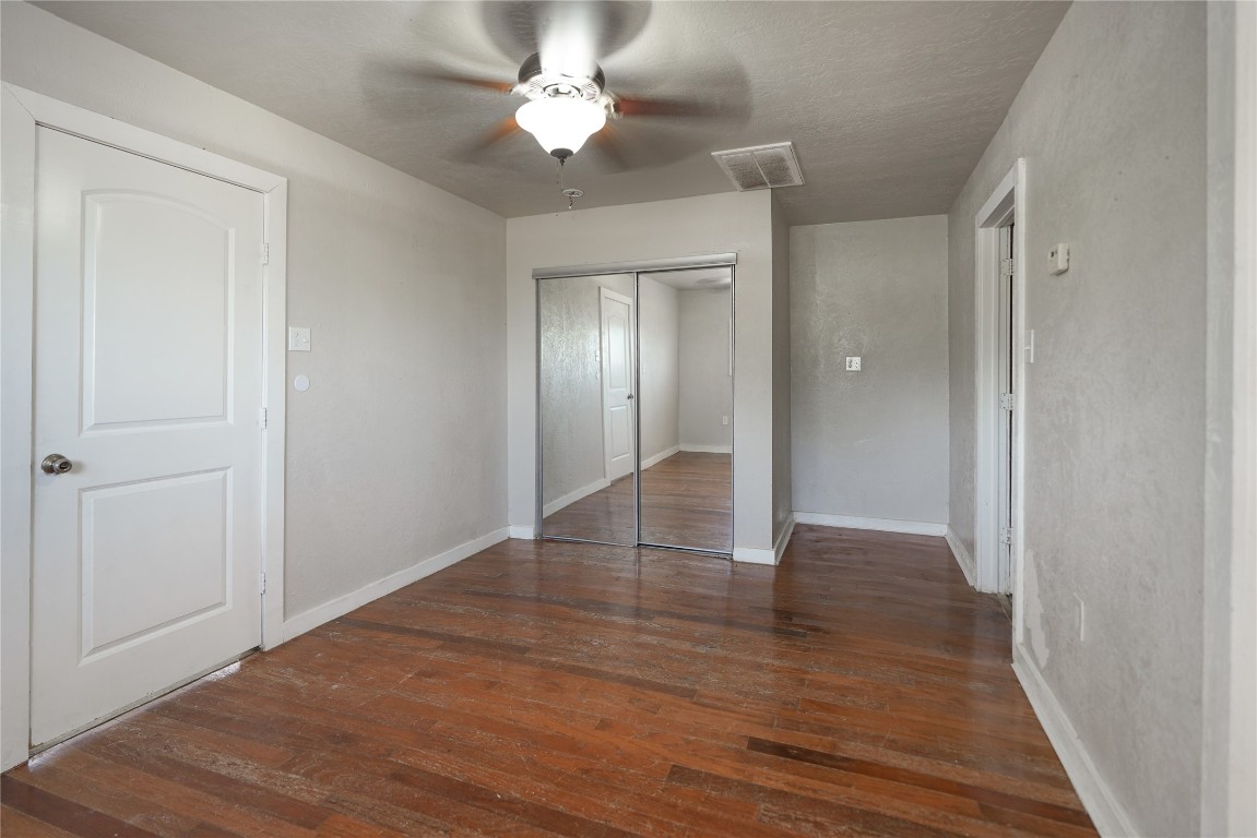 207 Riverside Street Highlands, TX 77562 - Photo 23 of 29 a view of an empty room with wooden floor