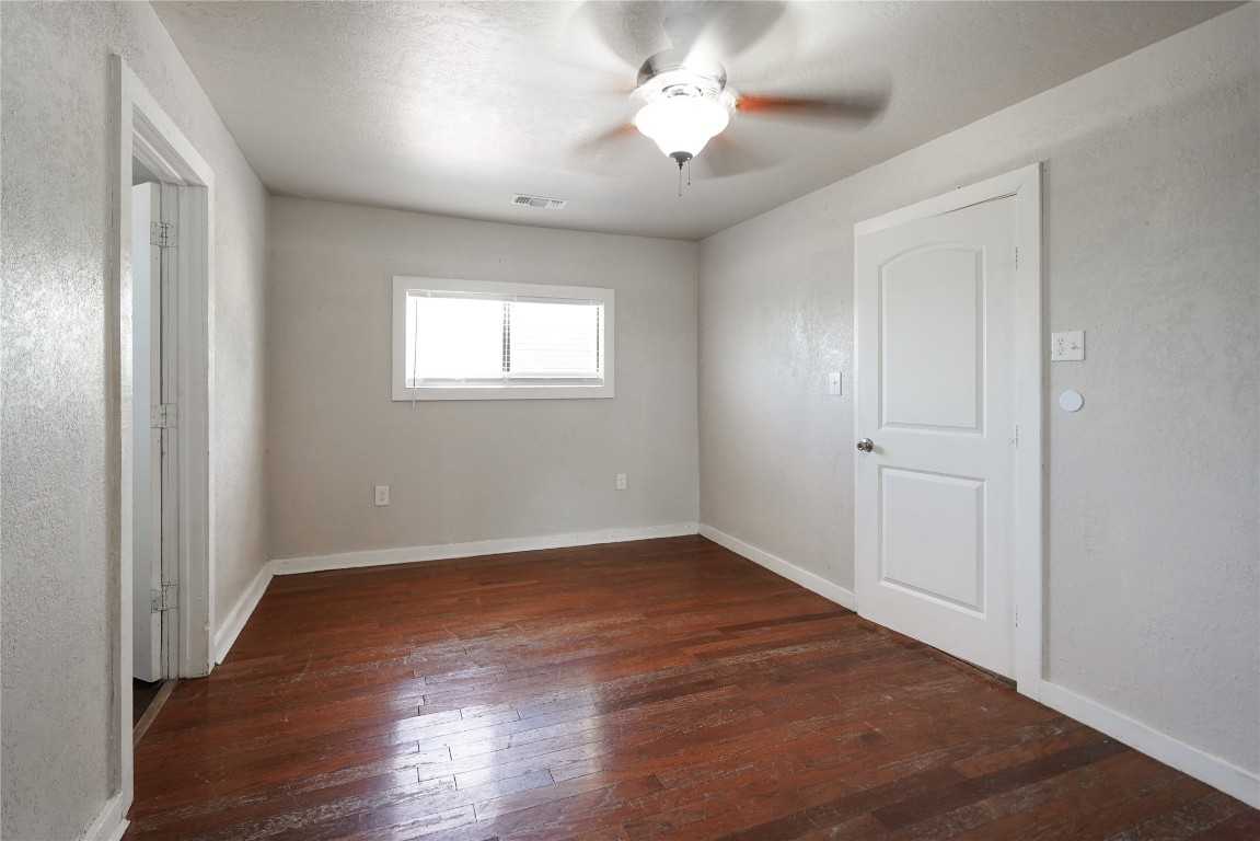 207 Riverside Street Highlands, TX 77562 - Photo 24 of 29 an empty room with wooden floor and windows