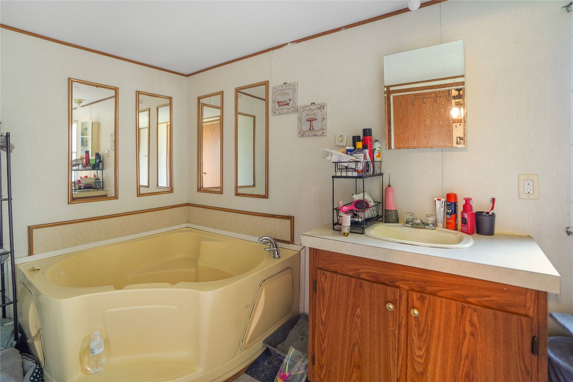 207 Riverside Street Highlands, TX 77562 - Photo 29 of 29 a bathroom with a tub sink and a mirror