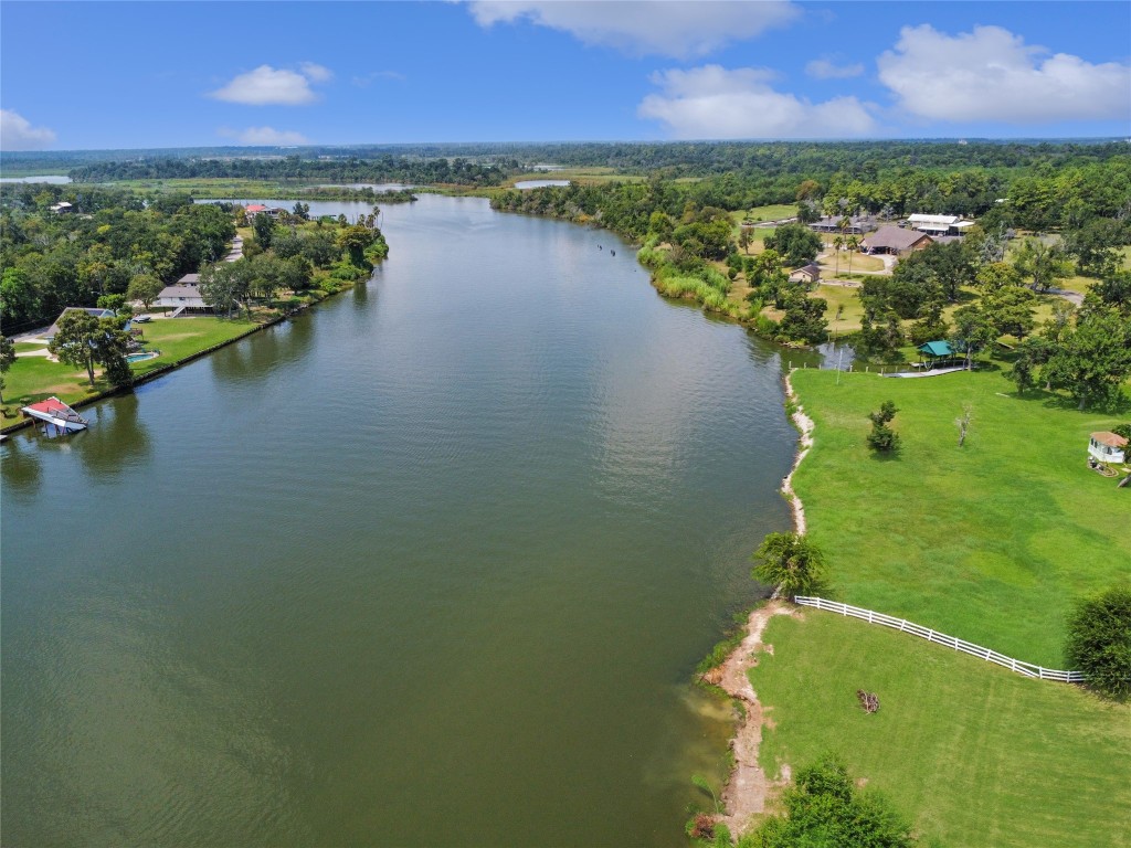 207 Riverside Street Highlands, TX 77562 - Photo 6 of 29 a view of a lake with houses in the back