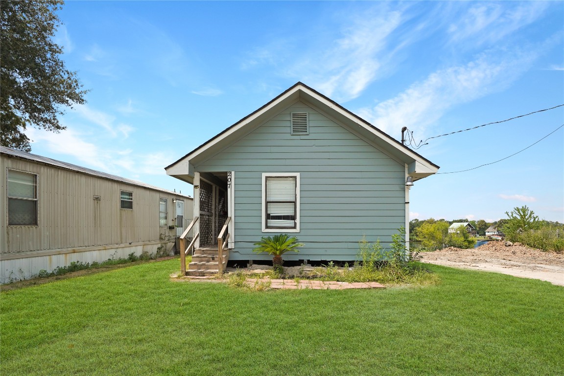 207 Riverside Street Highlands, TX 77562 - Photo 9 of 29 a view of a backyard with plants and a garden