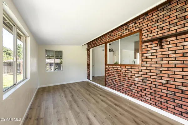 a view of a living room with furniture and flat screen tv