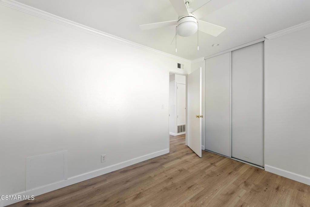 14773 Stanford Street Moorpark, CA 93021 - Photo 17 of 26 an empty room with wooden floor and chandelier fan