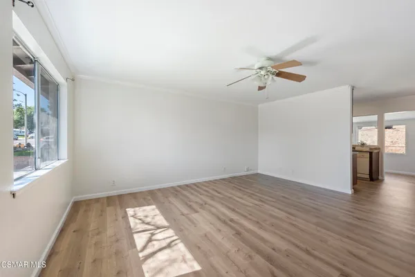 wooden floor in an empty room with a window