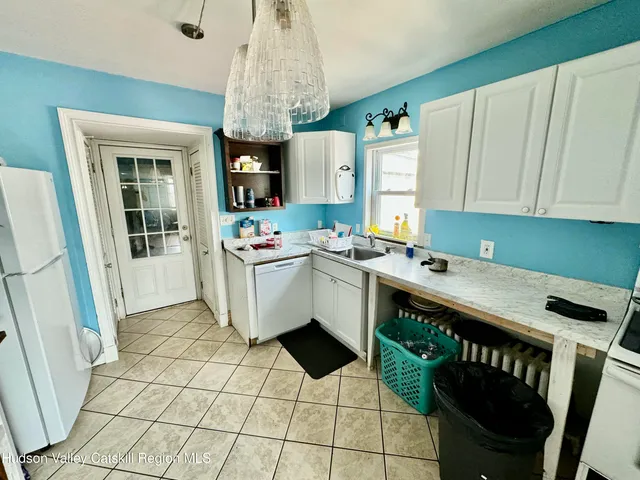 a kitchen with a sink a stove and cabinets