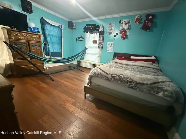 a bed sitting in a bedroom next to a window