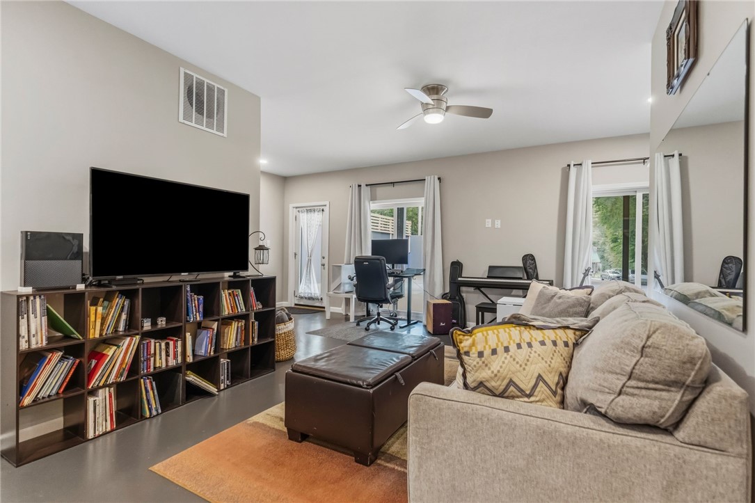 641 Lands End Road Seneca, SC 29678 - Photo 20 of 39 A versatile living area features built-in shelving, a ceiling fan, and direct access to the outdoors.
