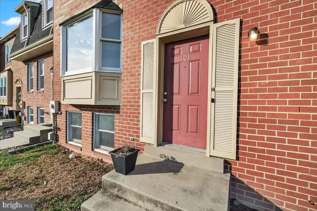 a view of a brick house with many windows