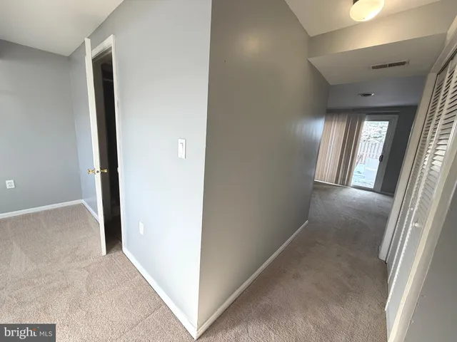 a view of a hallway with washer and dryer