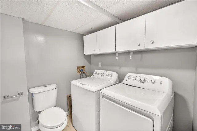 a view of backyard with wooden fence and trees