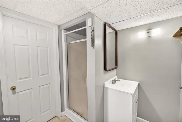 a view of a backyard with table and chairs and potted plants