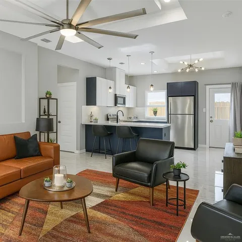 a living room with furniture and a view of kitchen