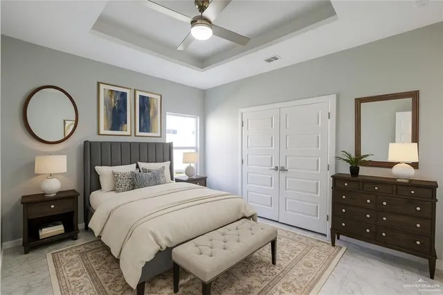 a bedroom with a large bed and a chandelier