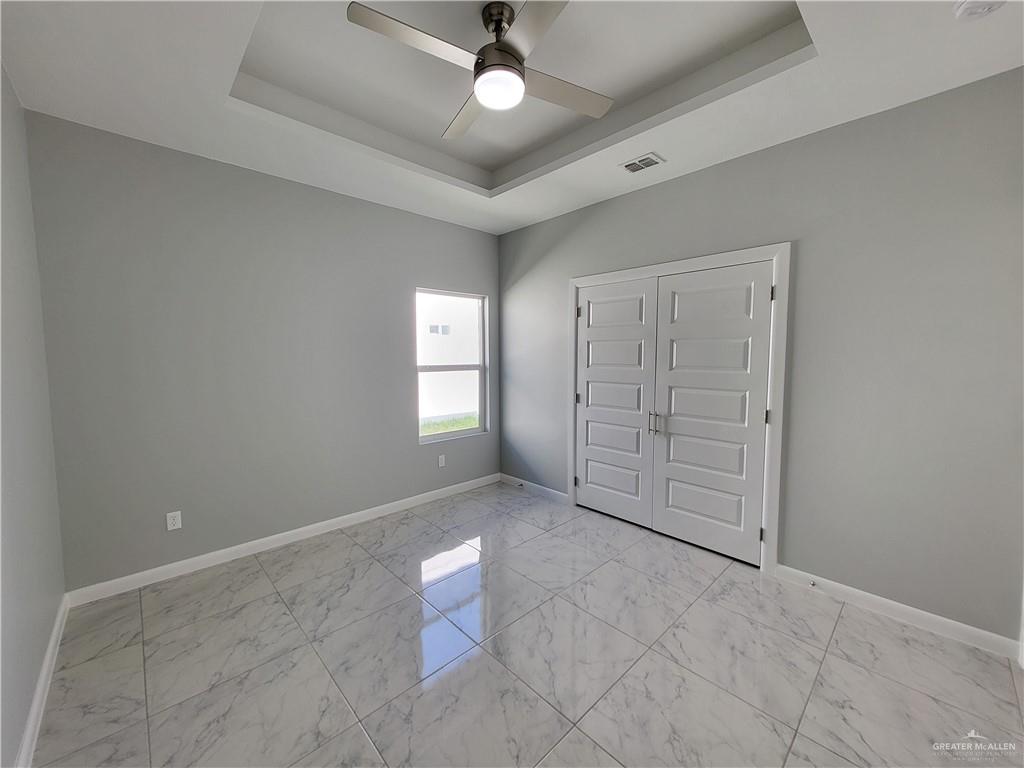1416 East Hibiscus Avenue, Unit 3 McAllen, TX 78501 - Photo 7 of 11 an empty room with fan and windows