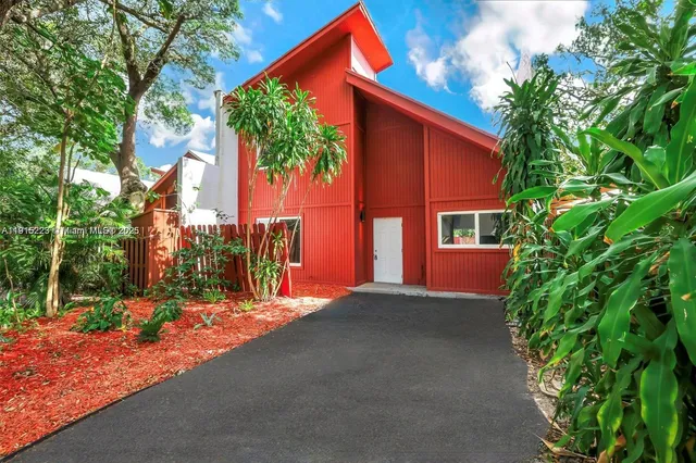 a wooden house with trees in front of it
