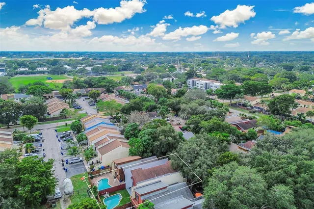 an aerial view of a houses with a yard