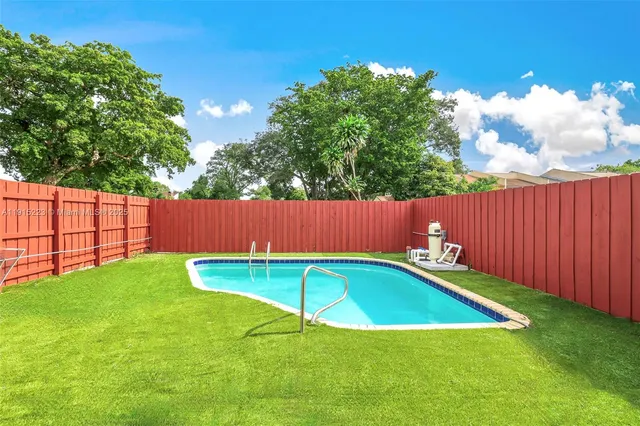 a view of a backyard with a swimming pool