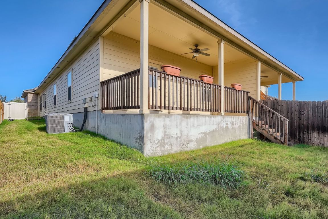 246 Joanne Loop, Unit B Buda, TX 78610 - Photo 11 of 11 View of side of property featuring ceiling fan and stairs
