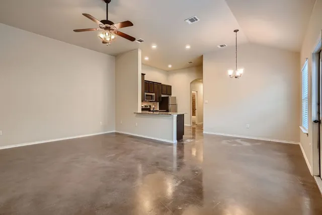 a view of an empty room with a kitchen