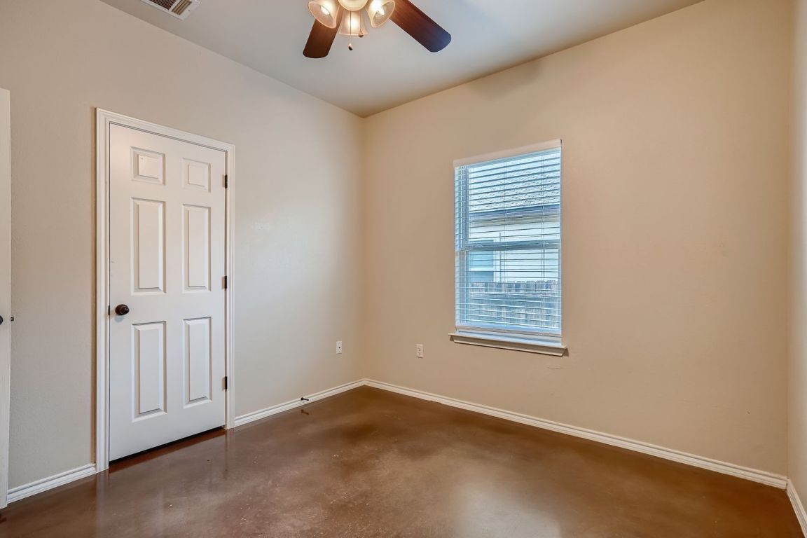 246 Joanne Loop, Unit B Buda, TX 78610 - Photo 8 of 11 Spare room featuring concrete floors and ceiling fan