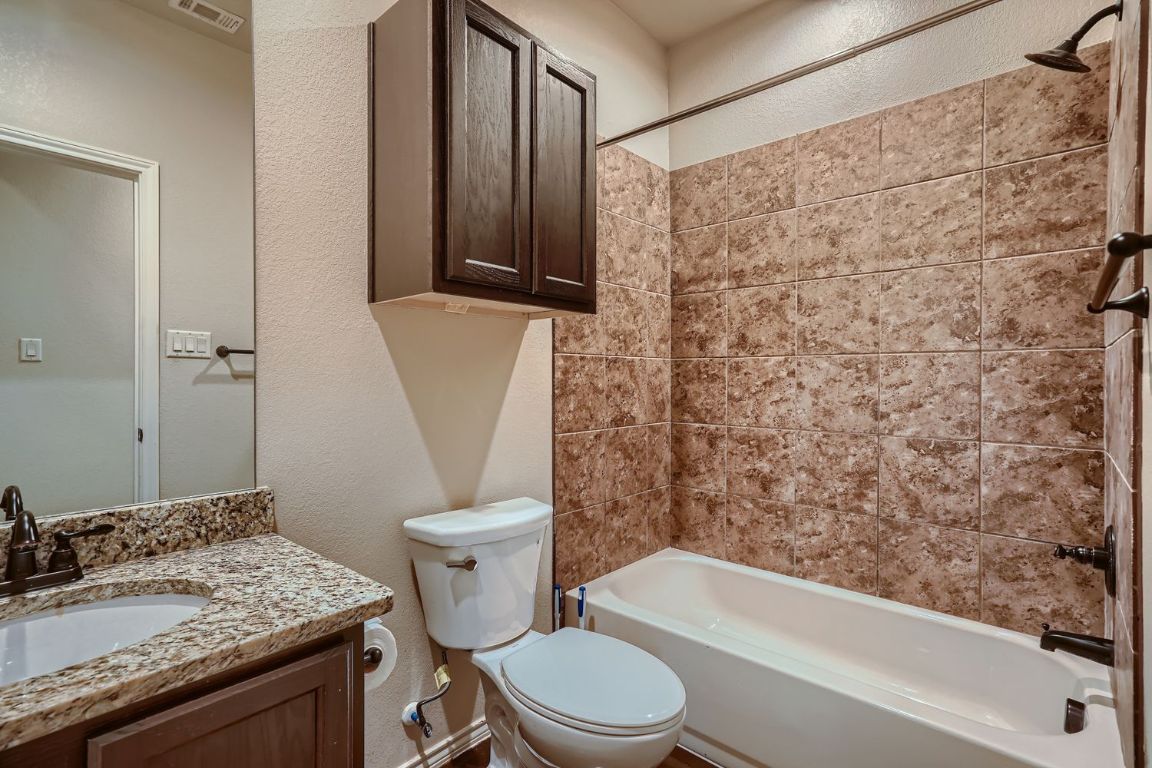 246 Joanne Loop, Unit B Buda, TX 78610 - Photo 9 of 11 Full bathroom with a textured wall, bathtub / shower combination, and vanity