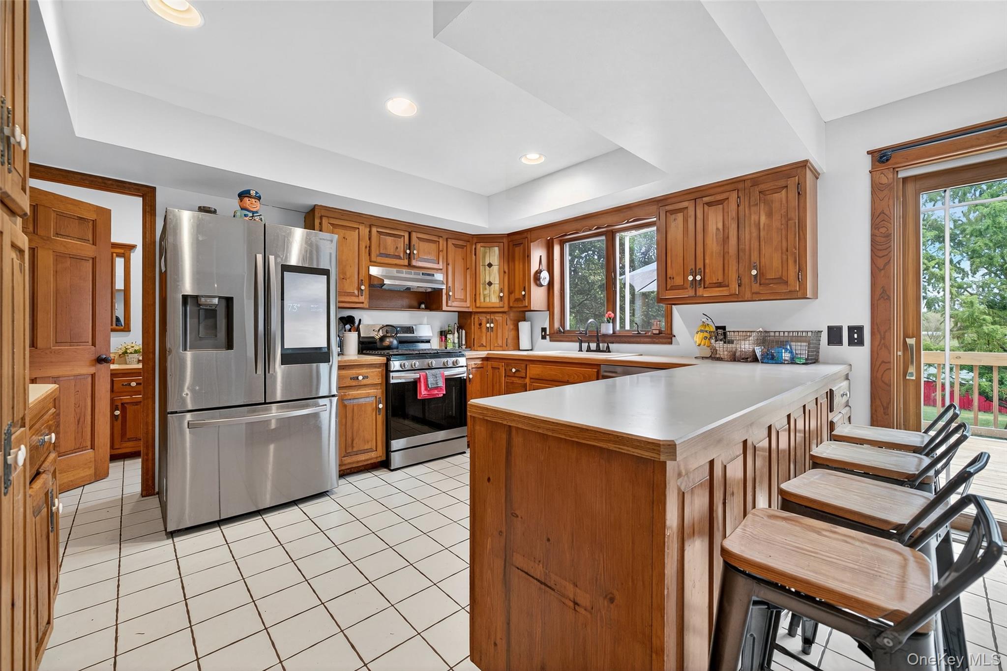 214 Dubois Road Gardiner, NY 12561 - Photo 11 of 38 a kitchen with a refrigerator a stove a sink dishwasher and a dining table with wooden floor