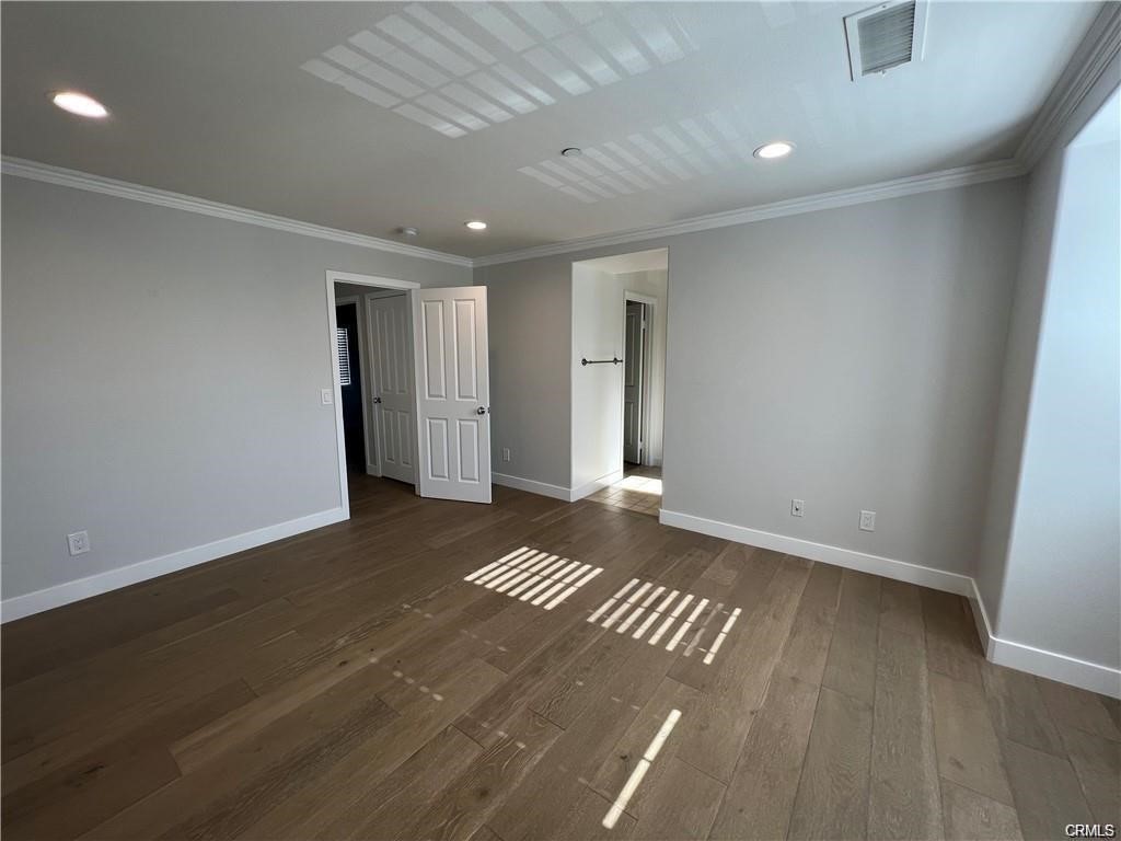 53 Bellwind Irvine, CA 92603 - Photo 5 of 12 an empty room with wooden floor and windows