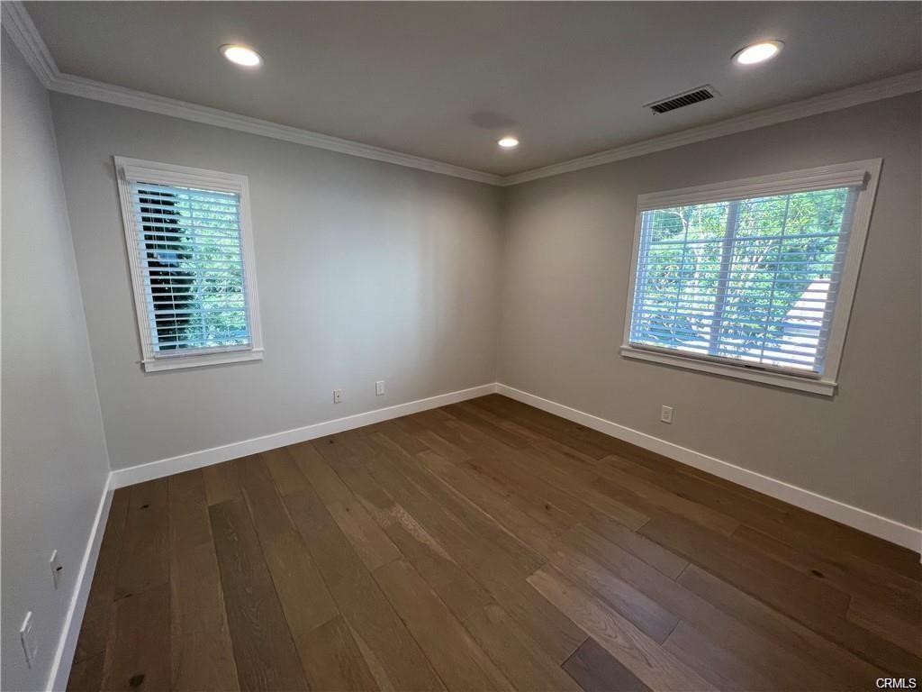 53 Bellwind Irvine, CA 92603 - Photo 6 of 12 a view of an empty room with wooden floor and a window