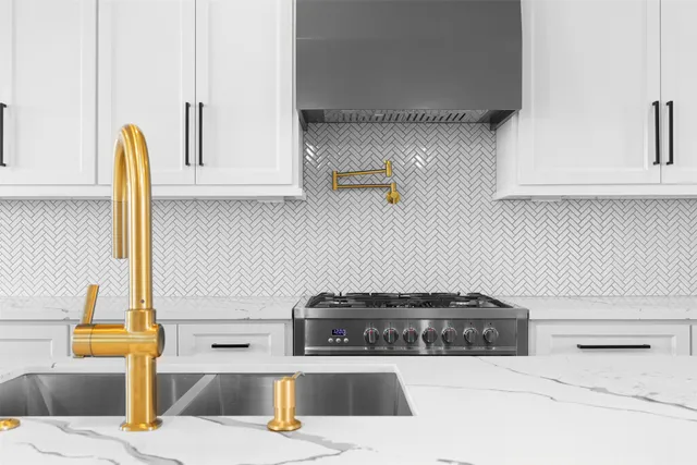 a kitchen with stainless steel appliances kitchen island a stove and a sink