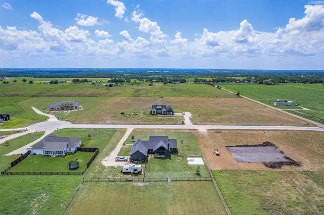 an aerial view of a house with yard swimming pool and outdoor seating