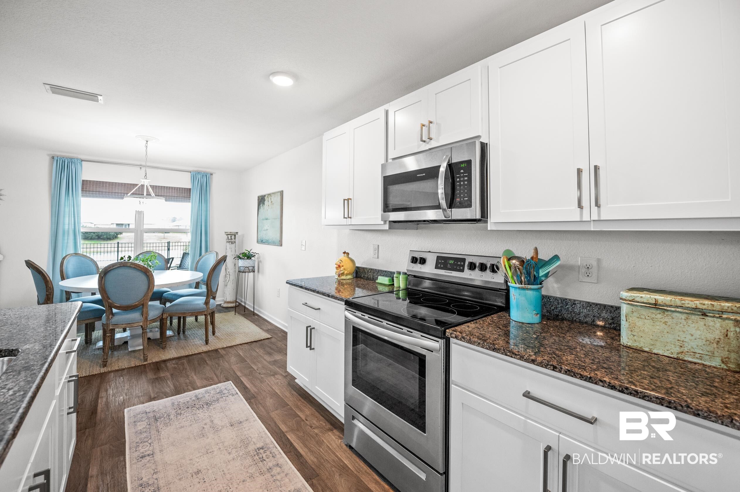 8161 Irwin Loop Daphne, AL 36526 - Photo 11 of 32 Kitchen with white cabinetry, pendant lighting, dark stone countertops, and appliances with stainless steel finishes
