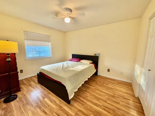 a bedroom with a bed and a chandelier