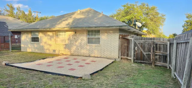 a view of a wooden house with a backyard