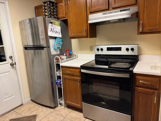 a stove top oven sitting inside of a kitchen