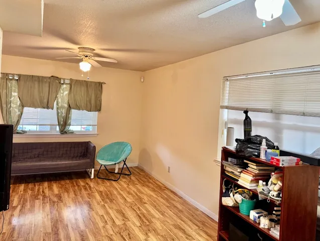a living room with a bed furniture and a window