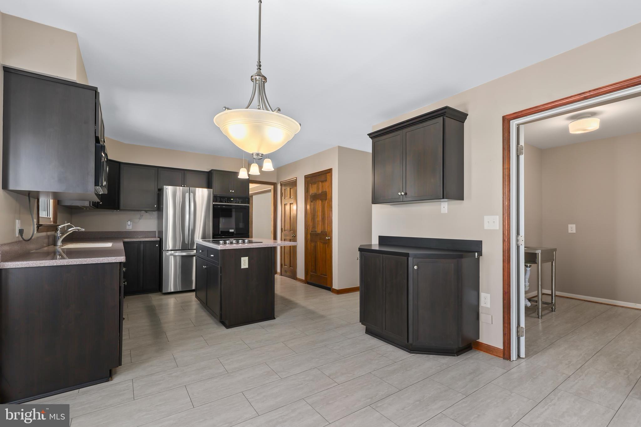 233 Choptank Road Stafford, VA 22556 - Photo 14 of 65 a kitchen with stainless steel appliances granite countertop a refrigerator a stove top oven a sink and dishwasher