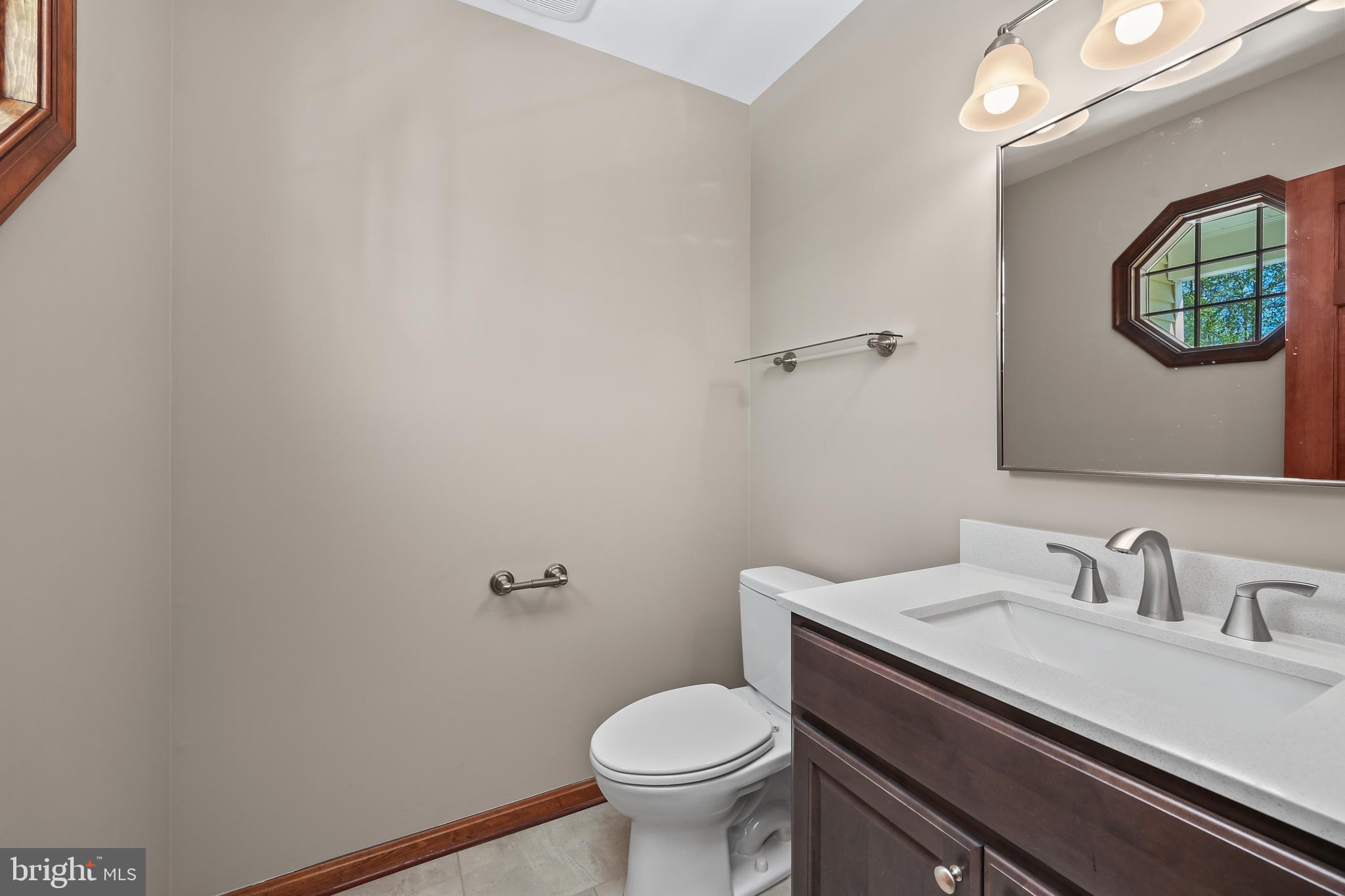 233 Choptank Road Stafford, VA 22556 - Photo 21 of 65 a bathroom with a toilet a sink and mirror