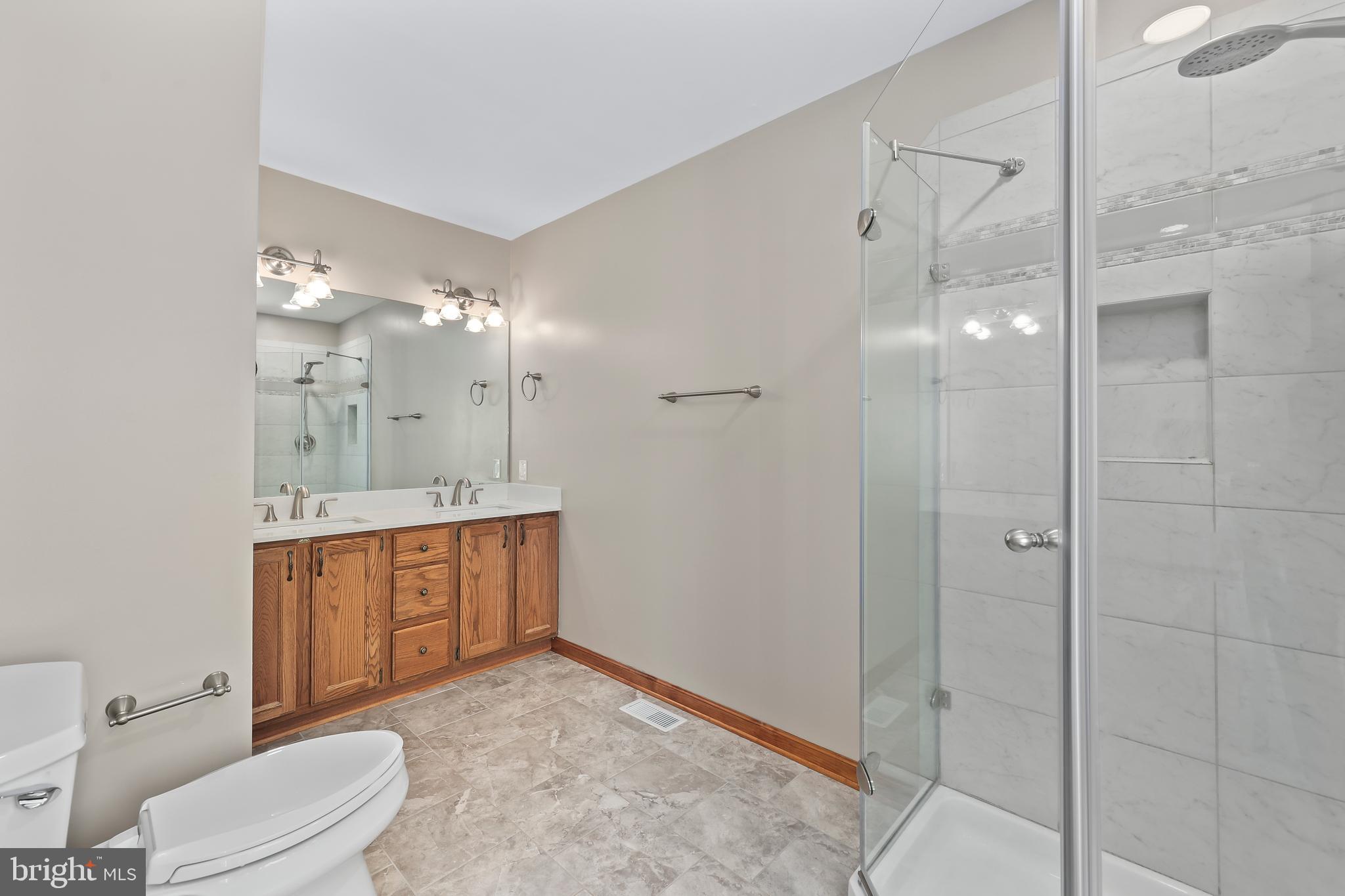 233 Choptank Road Stafford, VA 22556 - Photo 26 of 65 a bathroom with a sink a toilet and shower