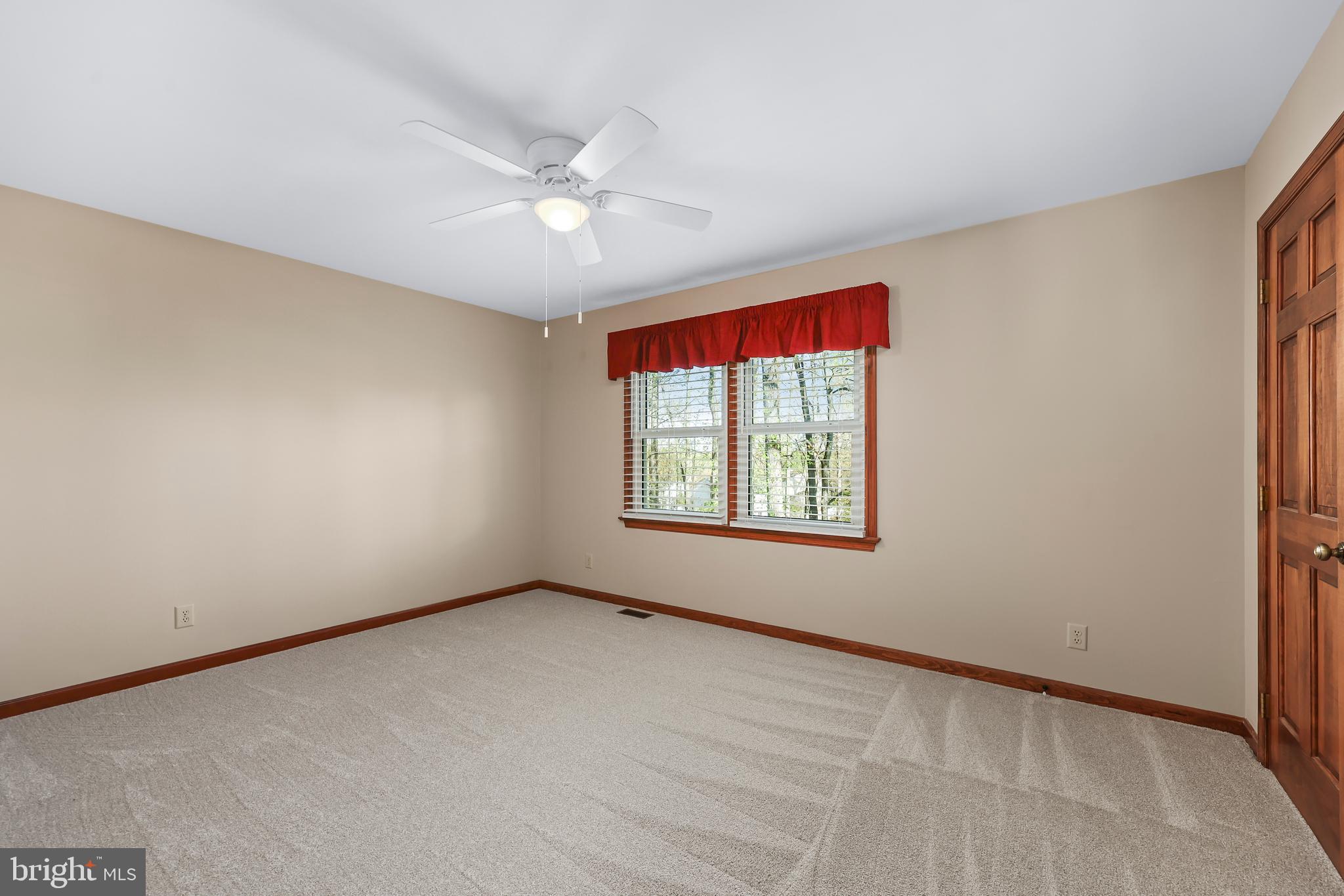 233 Choptank Road Stafford, VA 22556 - Photo 36 of 65 an empty room with a window and a fan