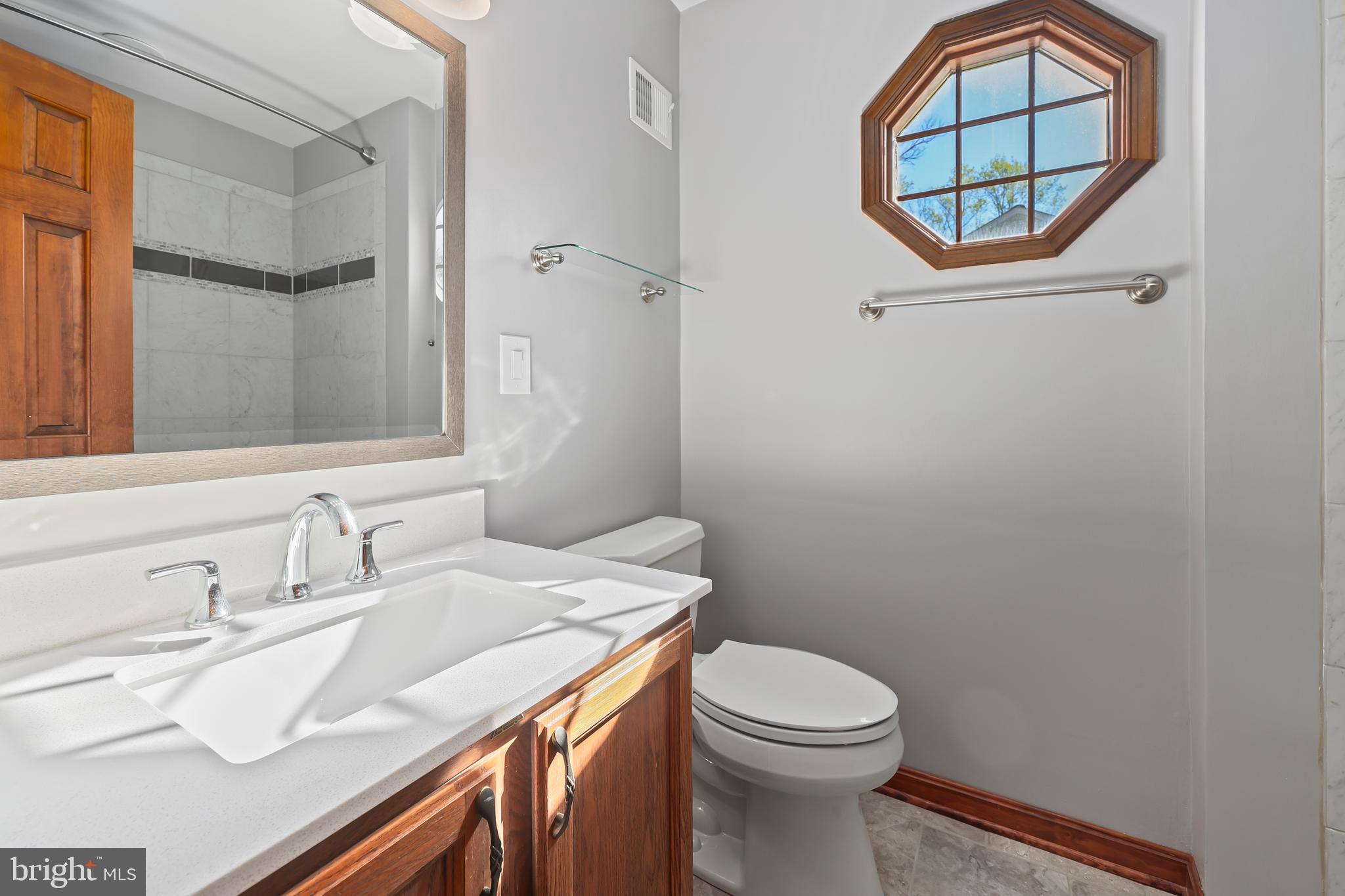233 Choptank Road Stafford, VA 22556 - Photo 39 of 65 a bathroom with a sink vanity mirror and toilet