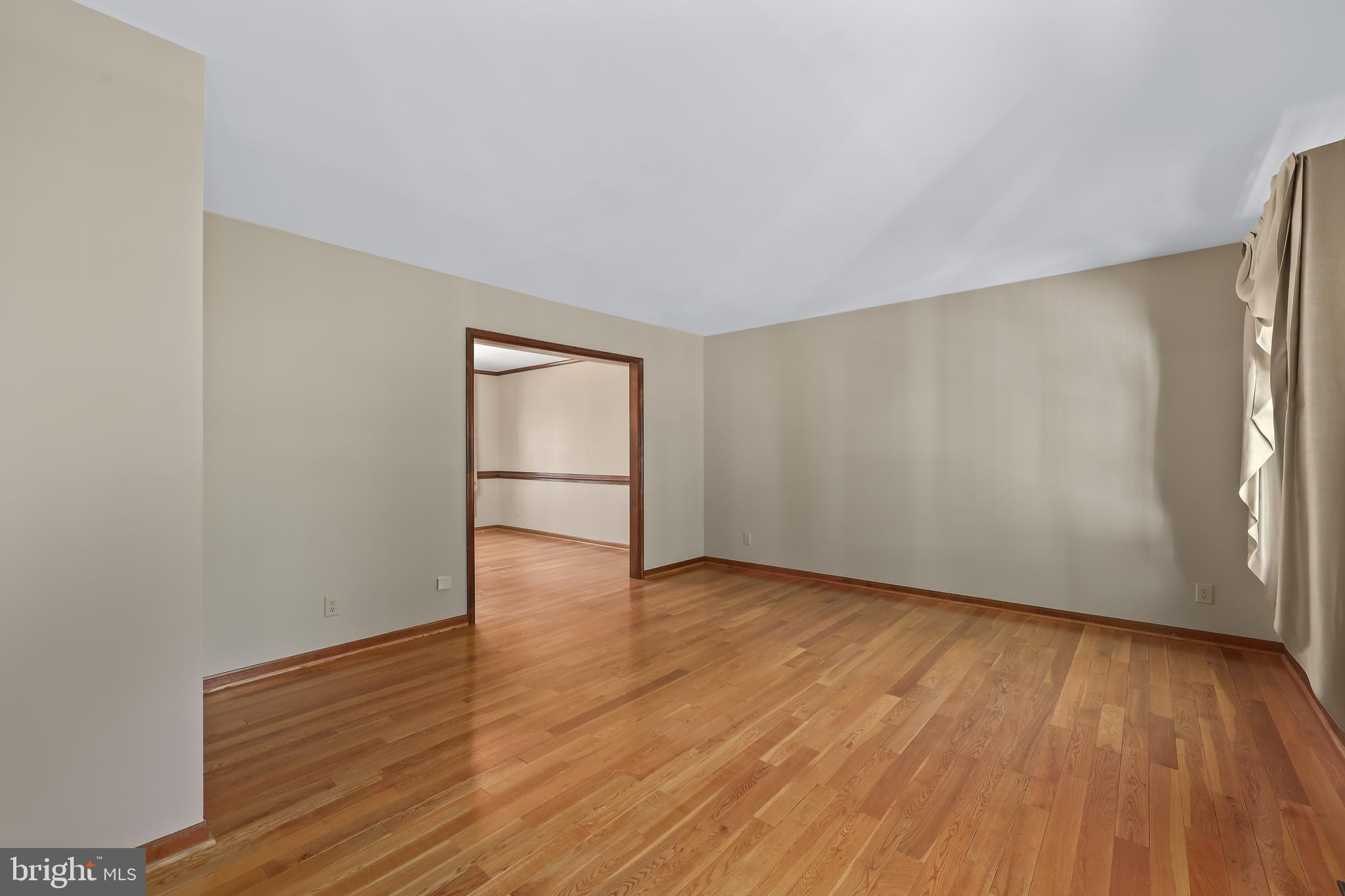233 Choptank Road Stafford, VA 22556 - Photo 5 of 65 a view of an empty room with wooden floor and a window