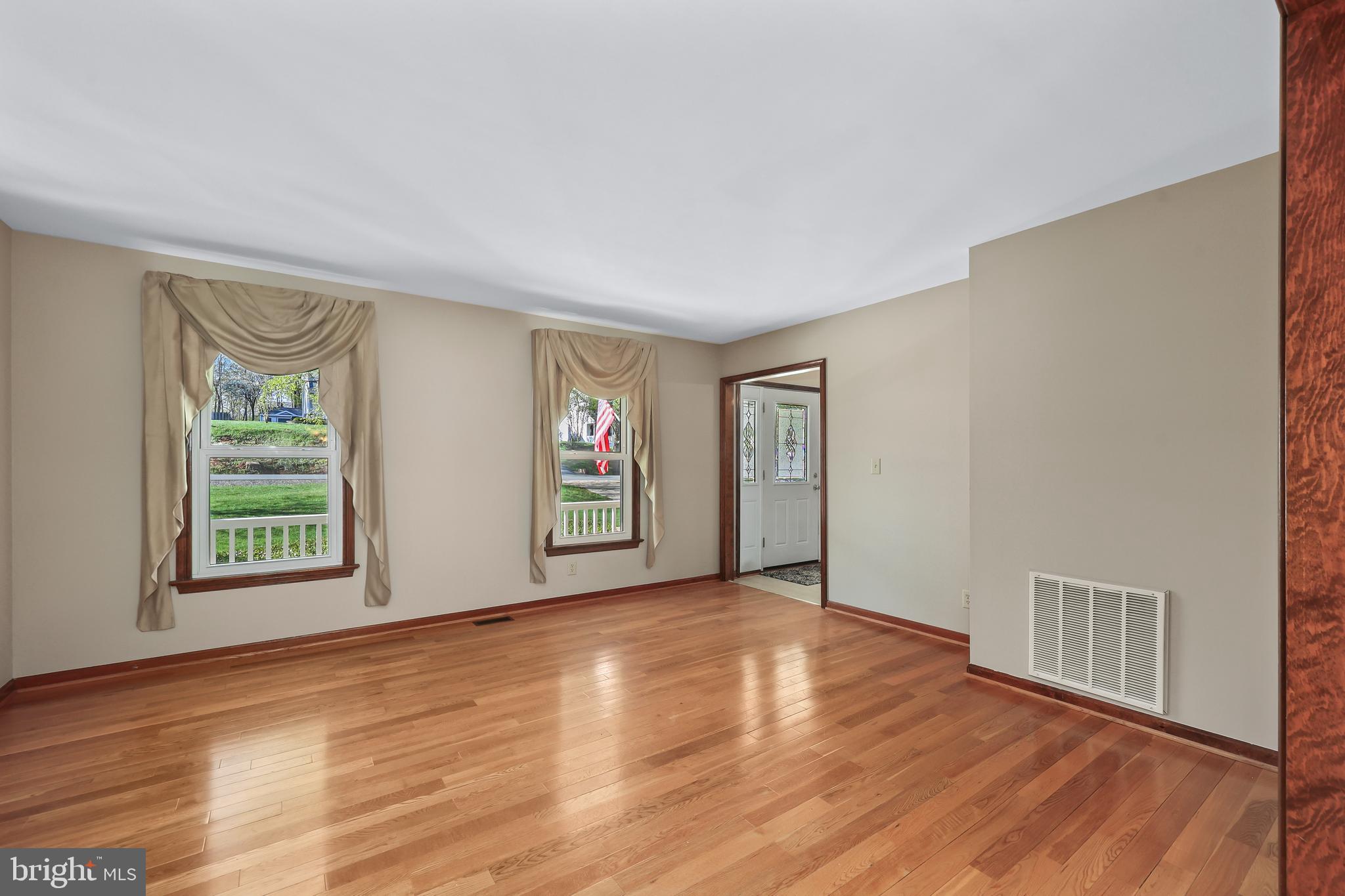 233 Choptank Road Stafford, VA 22556 - Photo 6 of 65 a view of an empty room with a window and wooden floor