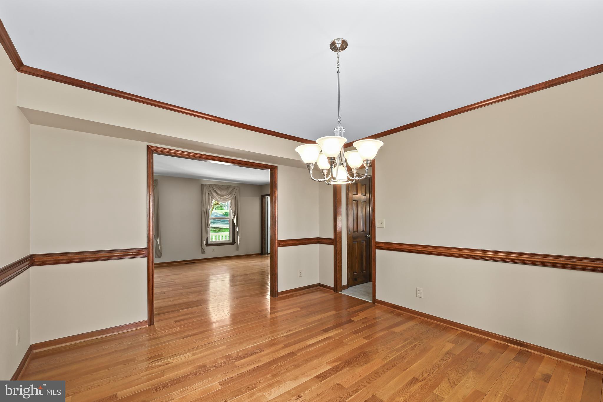 233 Choptank Road Stafford, VA 22556 - Photo 10 of 65 a view of a room with wooden floor chandelier and a window