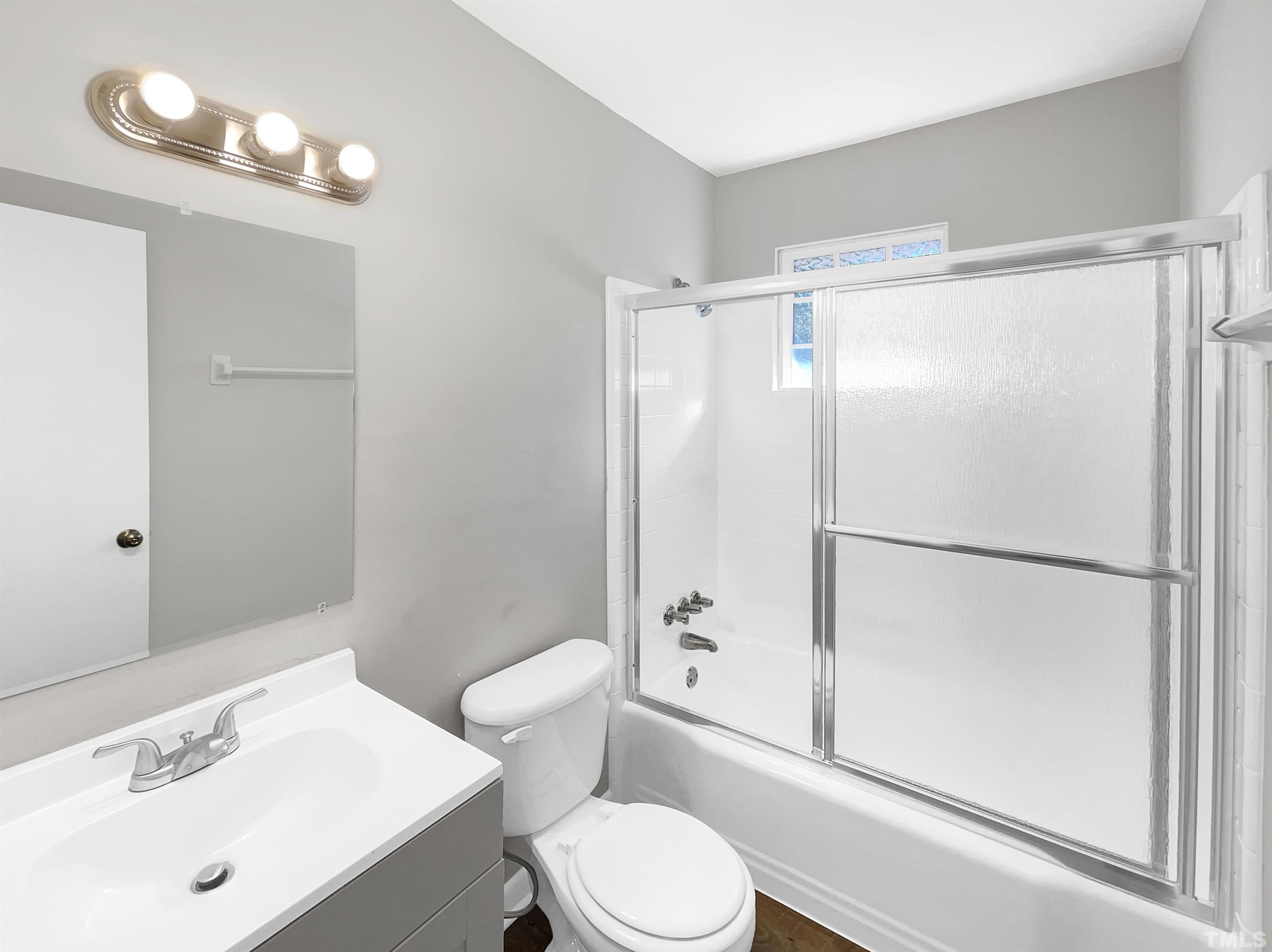 3703 Hester Circle Raleigh, NC 27604 - Photo 13 of 14 a white toilet sitting next to a bathroom sink