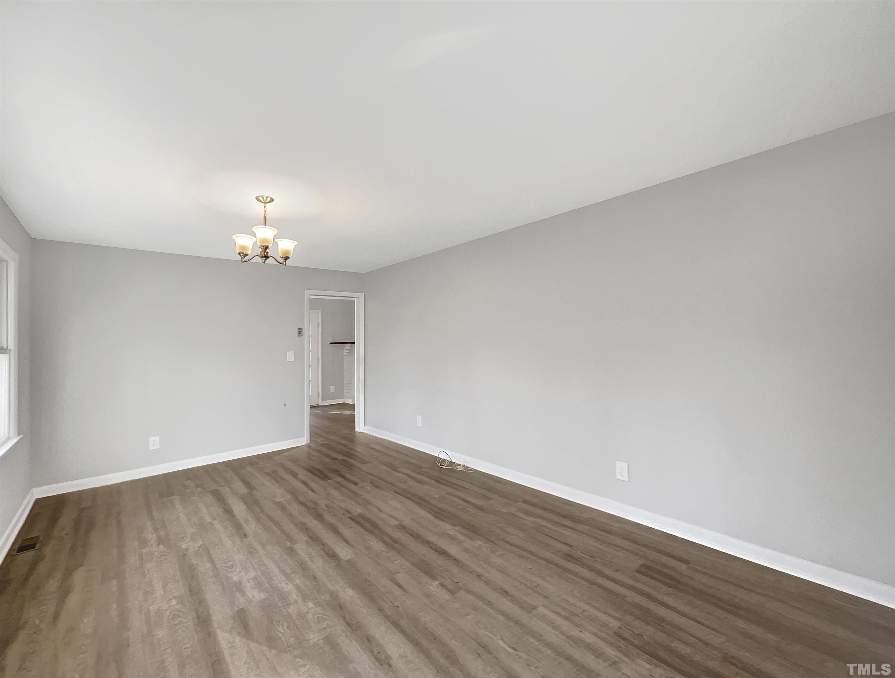 3703 Hester Circle Raleigh, NC 27604 - Photo 3 of 14 a view of an empty room with wooden floor and a window