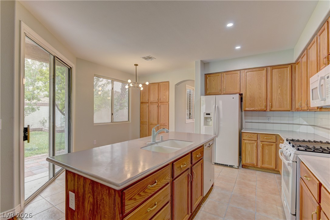 1813 Snow Spring Lane Las Vegas, NV 89134 - Photo 14 of 37 Functional kitchen with ample cabinetry and an island, ideal for daily routines.