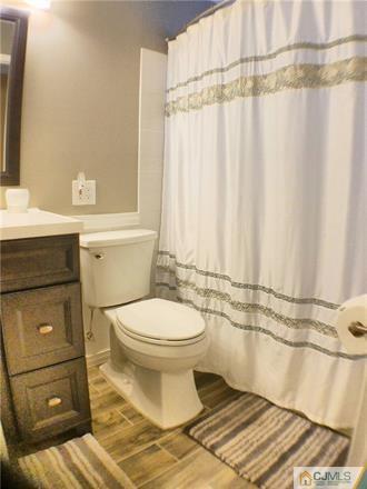 21 Ridge Road Old Bridge, NJ 08857 - Photo 14 of 23 a bathroom with a toilet and a shower curtain