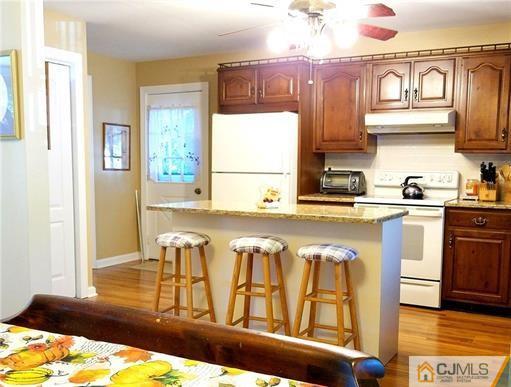 21 Ridge Road Old Bridge, NJ 08857 - Photo 3 of 23 a kitchen with stainless steel appliances granite countertop a sink and cabinets