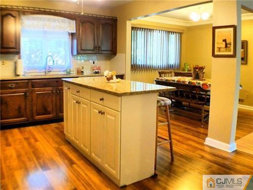 21 Ridge Road Old Bridge, NJ 08857 - Photo 5 of 23 a kitchen with wooden cabinets and a sink
