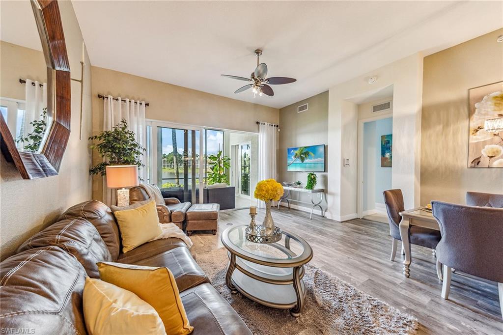 9275 Museo Circle, Unit 103 Naples, FL 34114 - Photo 11 of 49 a living room with furniture and a large window